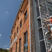 Climbing on the artificial outdoor wall with guide