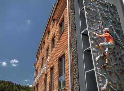 Climbing on the artificial outdoor wall with guide